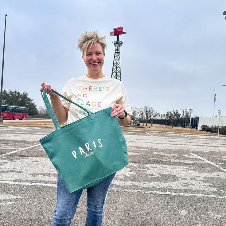 Looking for a stylish and practical bag? Check out this large seafoam tote bag made of durable canvas and dyed with a unique process. It features light pink lettering that says Paris, Texas, giving it a cool and quirky vibe. Whether you need a shopping bag or an everyday tote bag, this one has you covered. It has plenty of room for your essentials and more. Grab yours today and show off your personality with this awesome bag! Canvas Bag For Weekend In Spring, Casual Eco-friendly Canvas Travel Bag, Canvas Bags For Spring Weekend, Canvas Bag For Weekend And Spring Season, Trendy Cotton Canvas Bag For Weekend, Trendy Green Shoulder Bag For Weekend, Large Trendy Canvas Travel Bag, Green Canvas Bag With Letter Print For Everyday, Casual Green Canvas Bag For Weekend