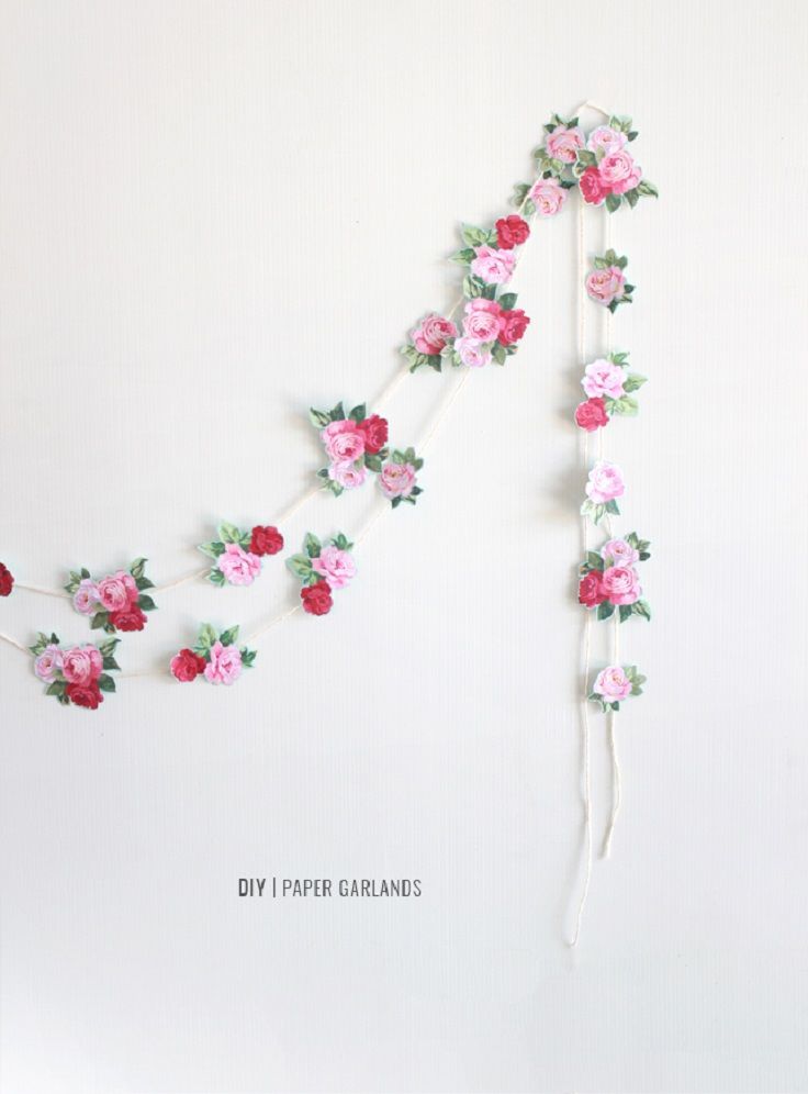 paper garland with pink and red flowers on white background