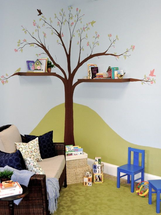 a child's room with a tree painted on the wall