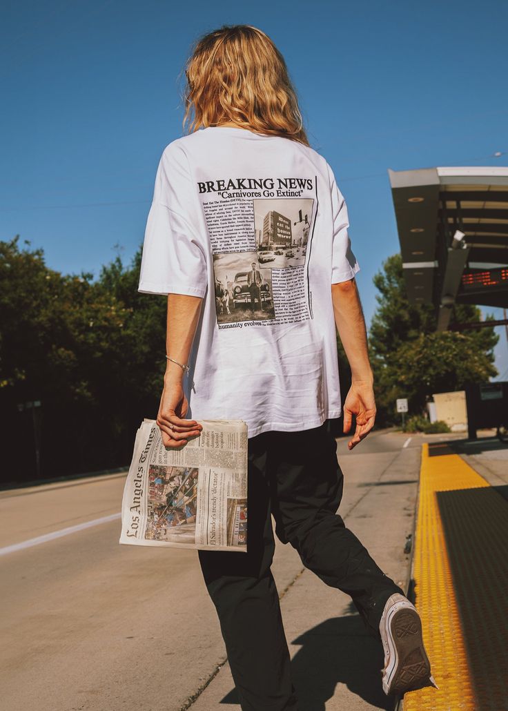 Our unisex white premium tee features the "Breaking News" graphic on the center back Fit: Unisex | Model is wearing size L 100% Cotton The Homies, Newspaper Printing, Work Organization, 10 Anniversary, The Movement, Organization Help, Printed Tees, 90s Fashion, Birthday Ideas