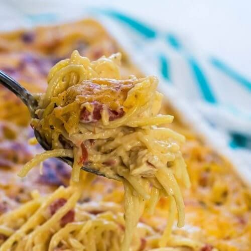 a spoon full of spaghetti with meat and cheese