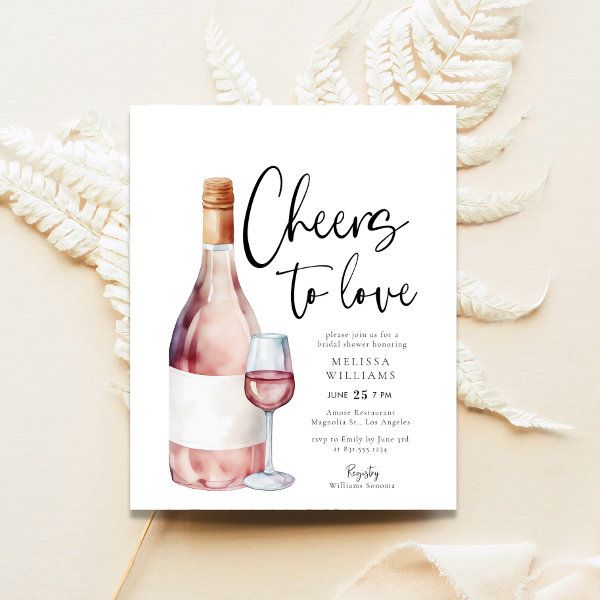 a wine bottle and glass are next to a card with the words cheers to love on it