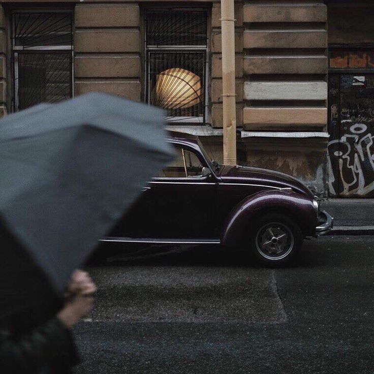 an old car parked on the street in front of a building