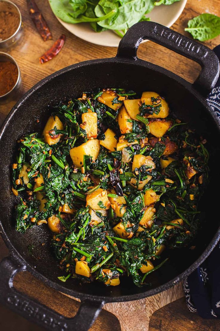 spinach and potato curry in a skillet