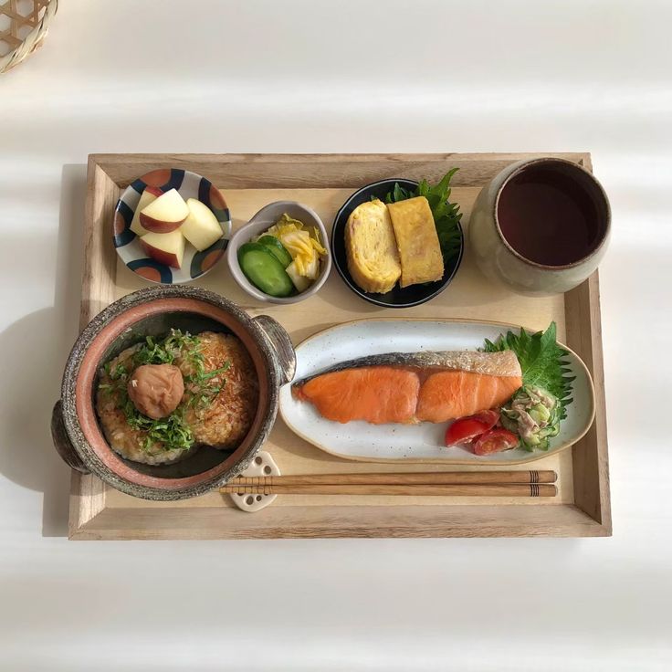 a wooden tray topped with different types of food