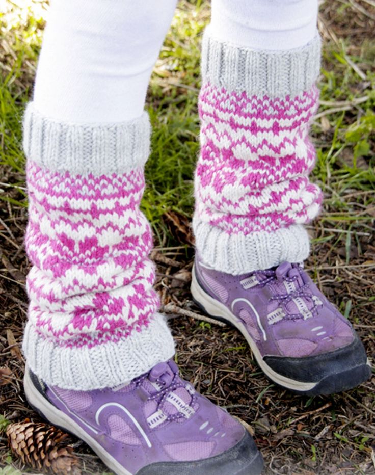 the legs and feet of a person wearing purple shoes with white socks, standing in grass