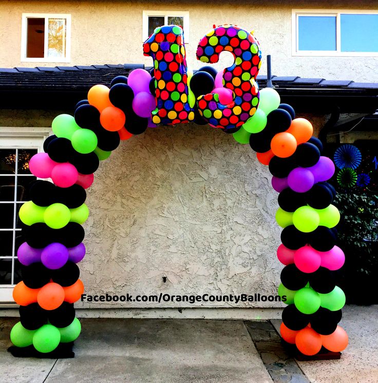 an entrance to a house decorated with balloons and the number twenty five in front of it