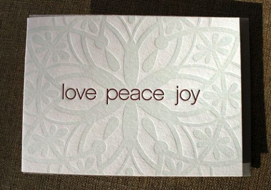 a card with the words love peace joy on it