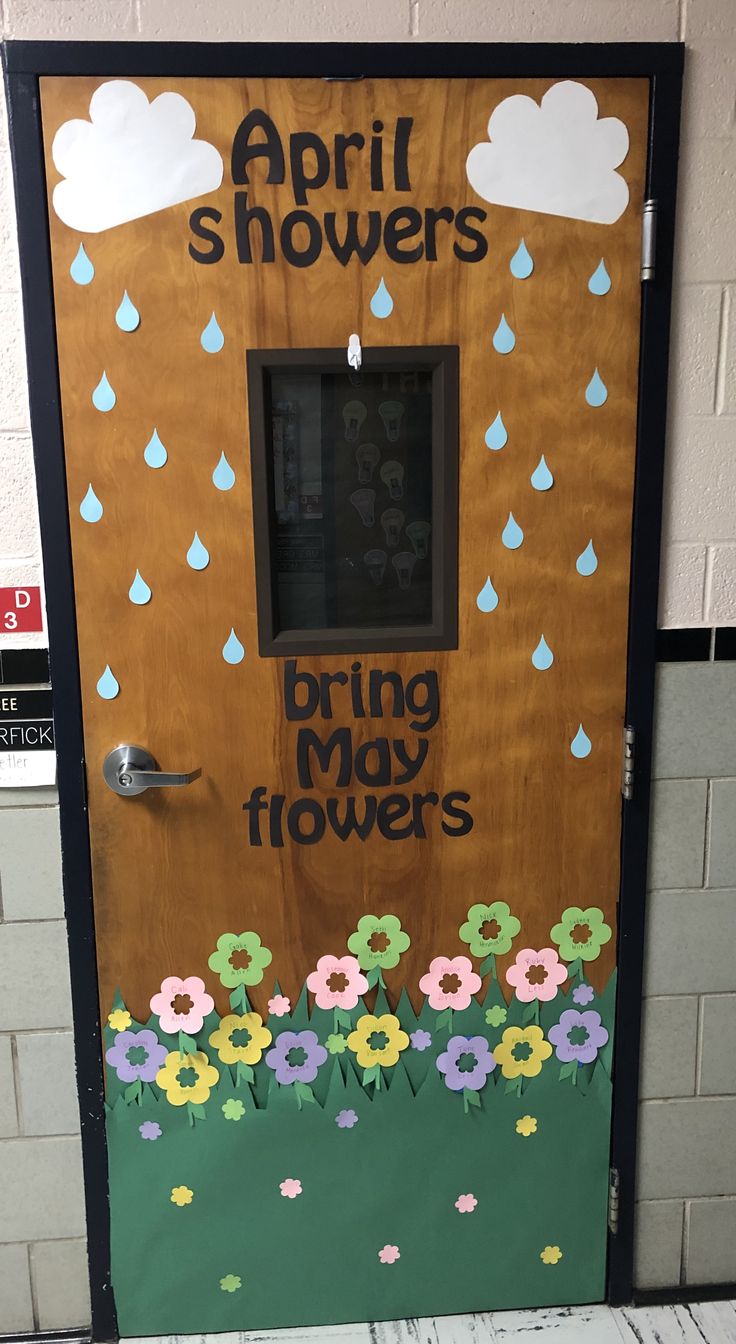 a door decorated with flowers and raindrops for the spring showers event at school