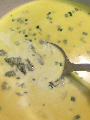 a spoon in a bowl filled with soup