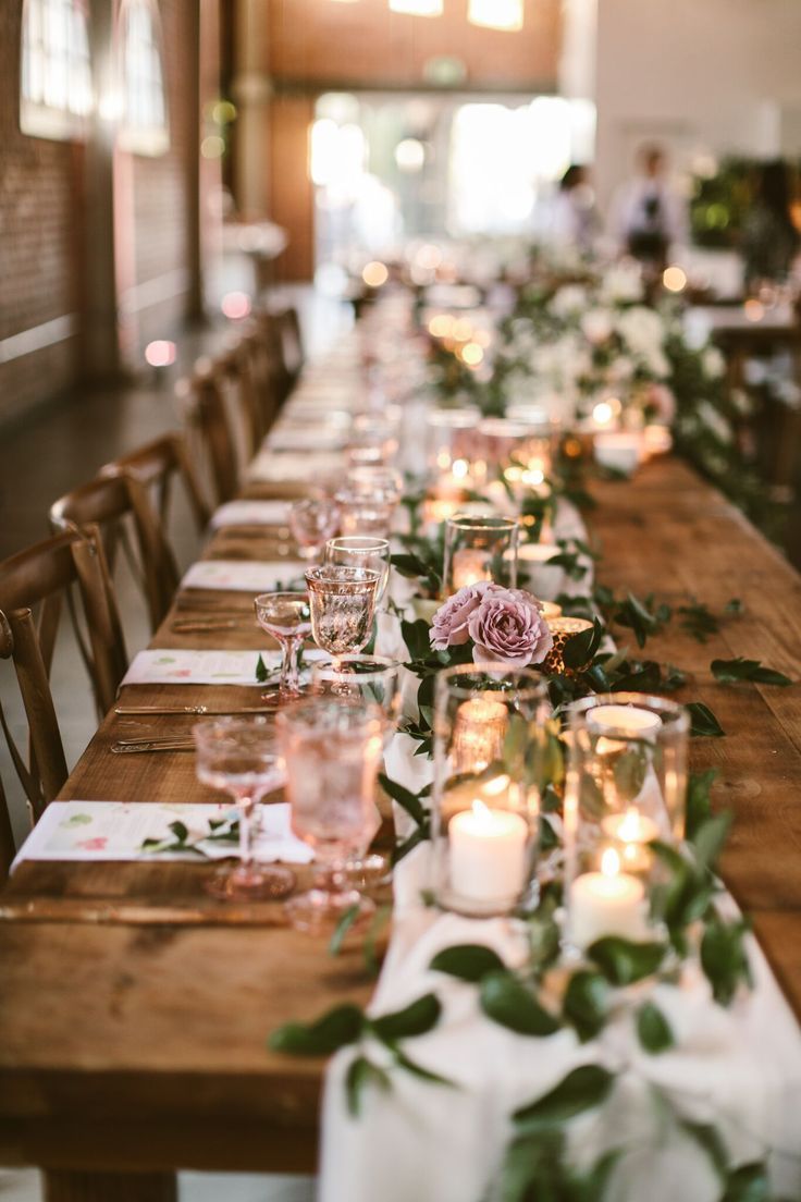 a long table with candles and flowers on it