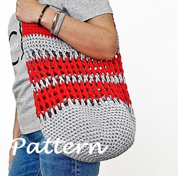 a woman carrying a large red and white knitted tote bag with holes in it