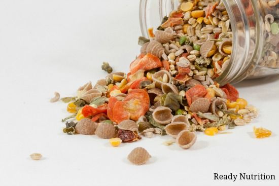 a glass jar filled with lots of different types of cereals and nuts on top of a white surface