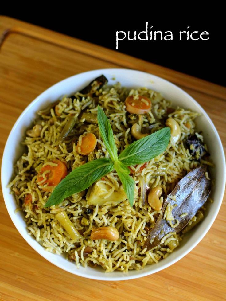 a white bowl filled with food on top of a wooden table