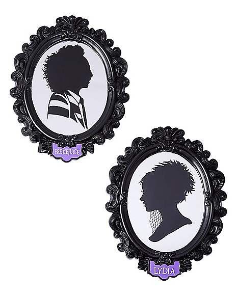 two black and white silhouettes of people in oval frames with purple lettering on them