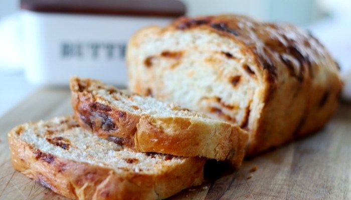 a loaf of bread sitting on top of a wooden cutting board