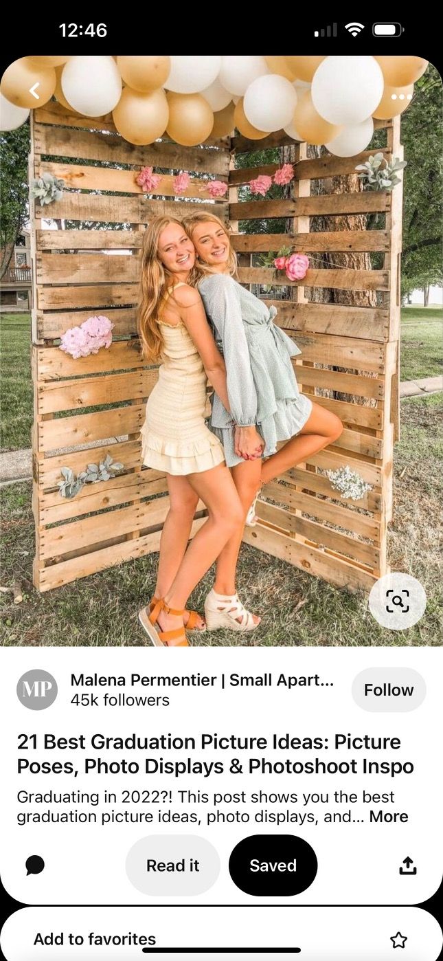 two girls posing in front of a wooden crate with balloons on the top and bottom