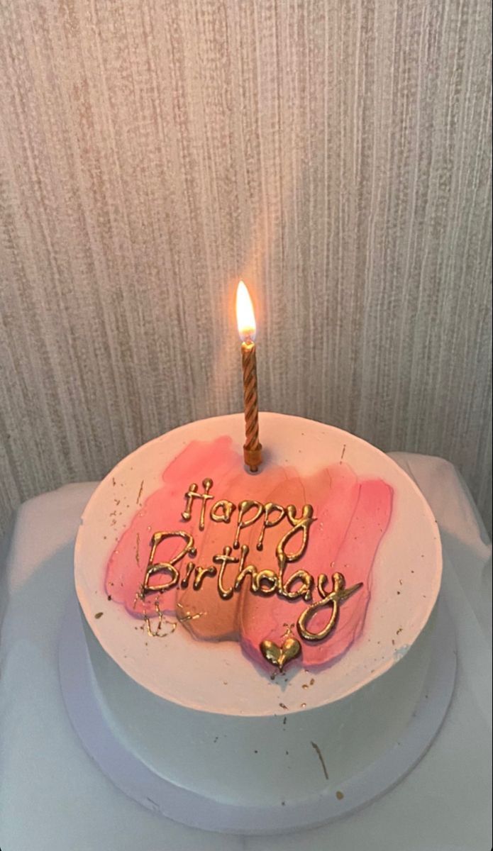 a birthday cake with the words happy birthday written on it and a single lit candle