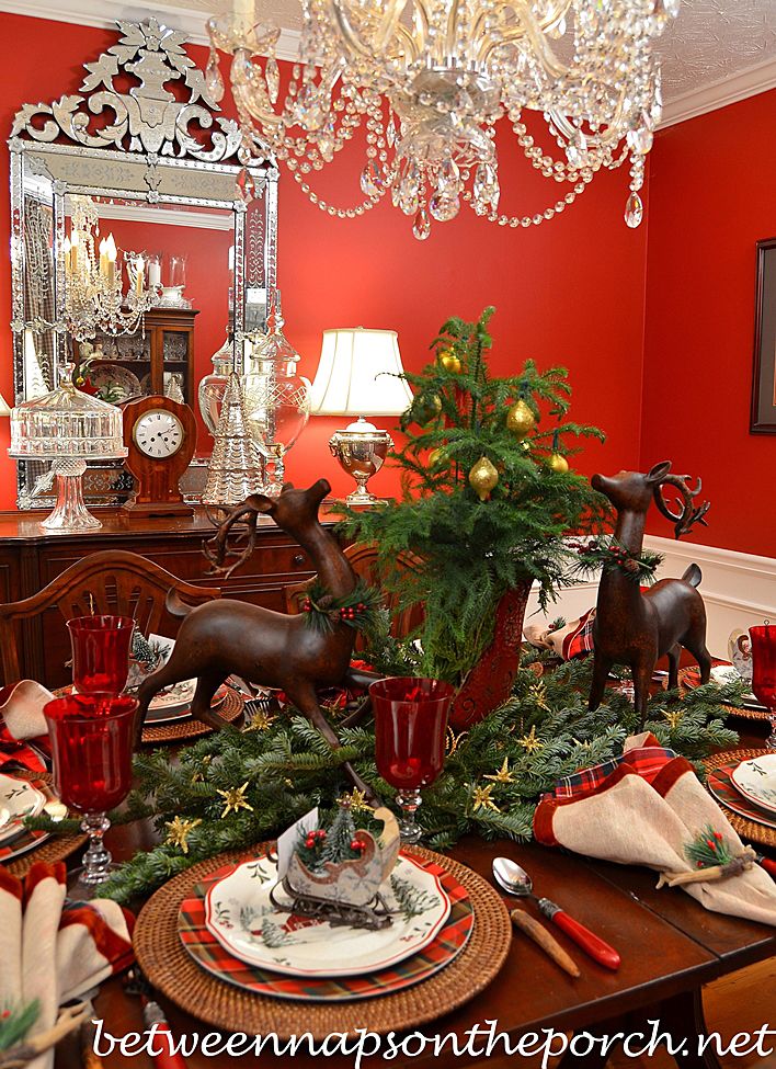 a dining room table decorated for christmas