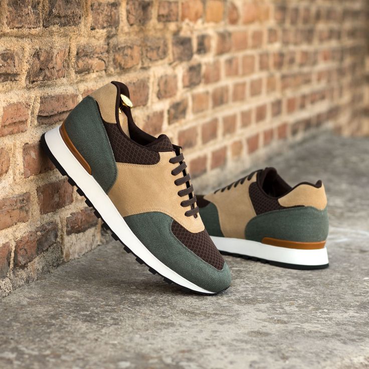 a brown and green sneaker sitting against a brick wall