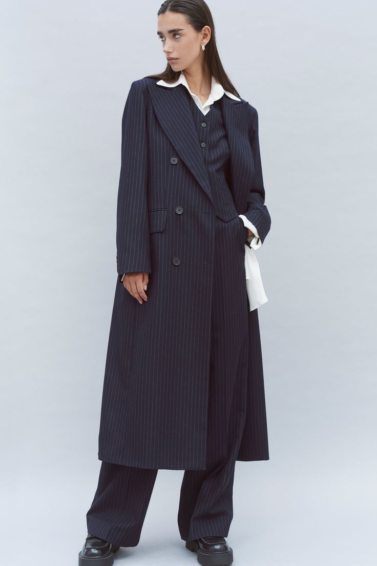 Our oversized double breasted tailored wool coat is made with 100% pinstripe wool woven in Yorkshire. The lining is sustainable made from FSC & Eco Vera viscose. The coat is long in length, it features an oversized lapel detail, horn buttons and two front pockets with a flap. The thread used on this garments is sustainable. Character Costume, Character Costumes, Wool Coat, Yorkshire, Horn, Double Breasted, Thread, Wool, How To Wear