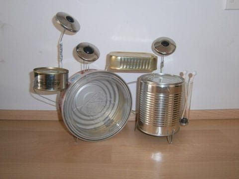 an assortment of tin cans sitting on top of a wooden floor