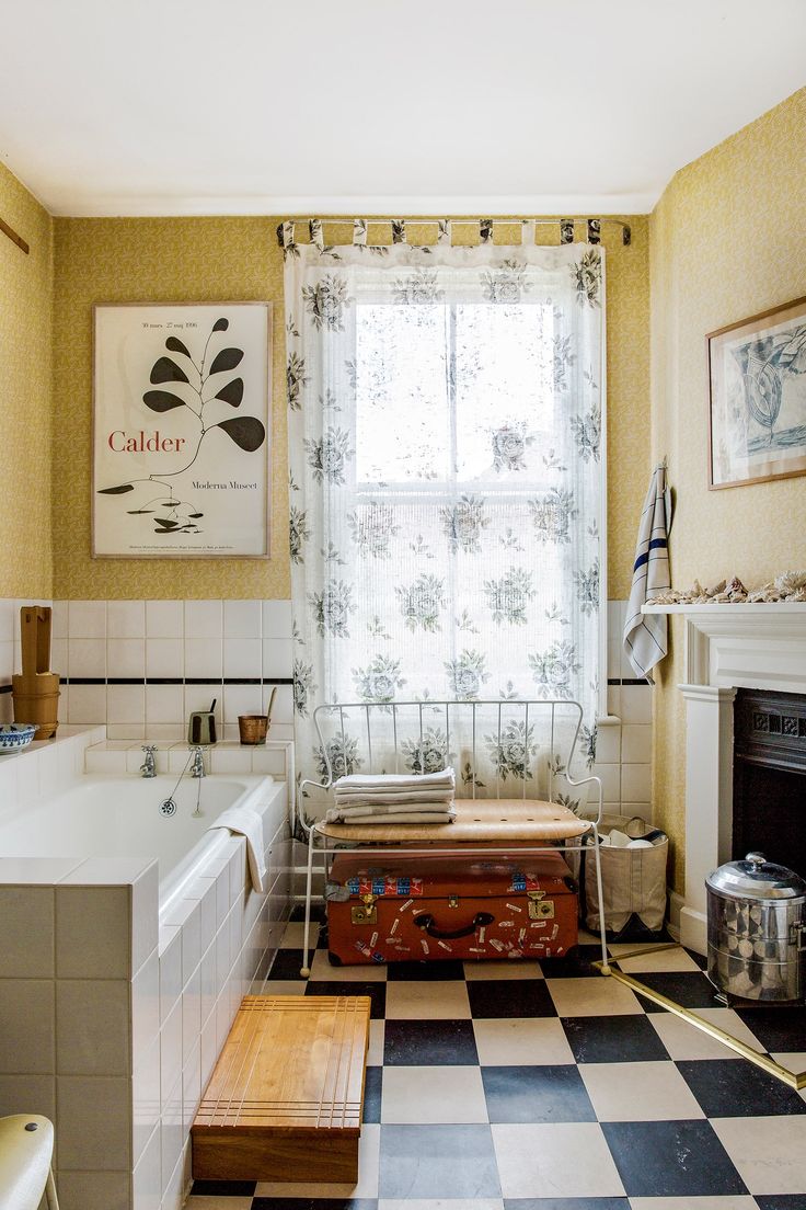 an old fashioned bathroom with checkered flooring and yellow walls is pictured in this image