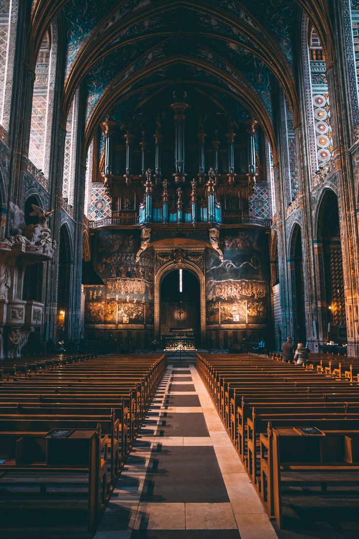 the inside of an old church with pews