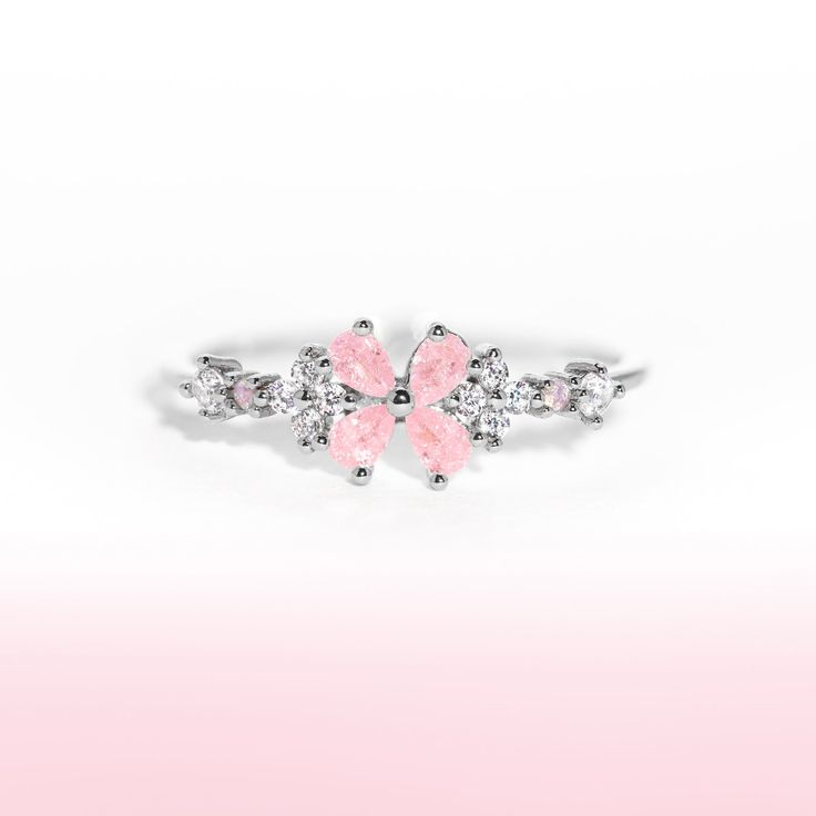 This ring is for everyone, but especially for all of our girly twirly pops! Our Bravissimo Ring adds the perfect amount of pink and sparkle to your stack! Rose Gold Flower Rings For Party, Pink Flower Promise Ring, Pink Rings For Party, Dainty Pink Stackable Rings For Wedding, Adjustable Pink Flower Ring For Wedding, Elegant Pink Crystal Ring For Party, Pink Flower-shaped Promise Ring, Pink Feminine Rings For Anniversary, Feminine Pink Rings For Anniversary