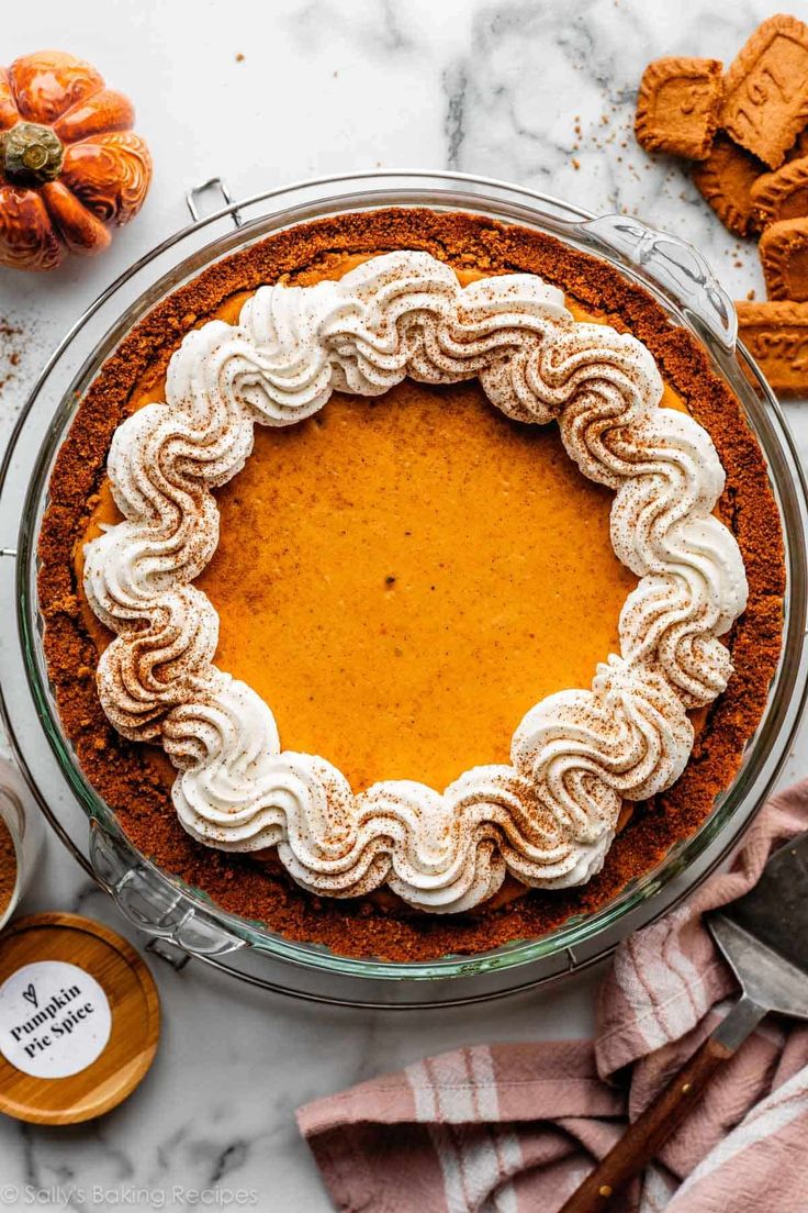 a pie sitting on top of a table next to other desserts and utensils