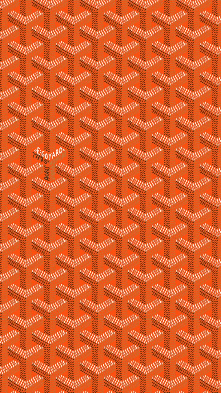 an orange and black pattern with white dots on the bottom, in front of a red background