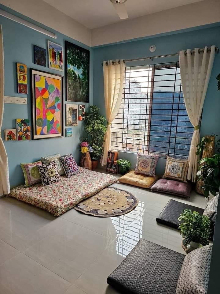 a living room filled with lots of furniture and pictures on the wall next to windows