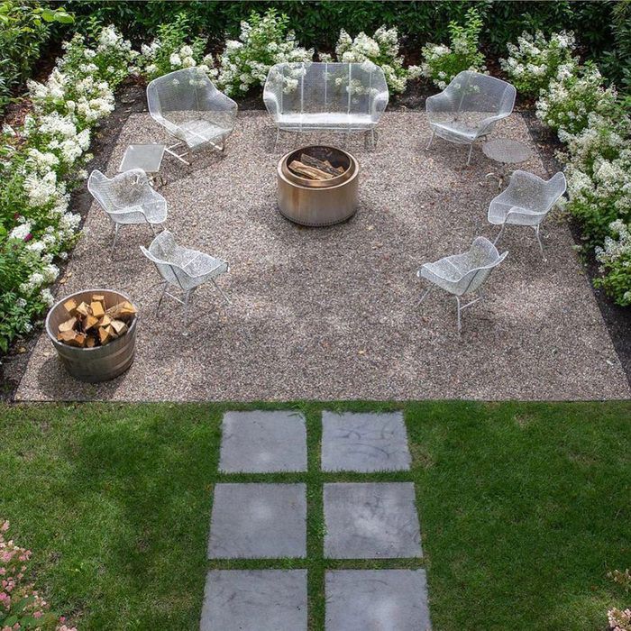 an outdoor fire pit surrounded by lawn furniture