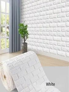 the white brick wallpaper is next to a potted plant