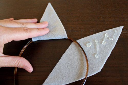 someone is making an origami bird out of felt