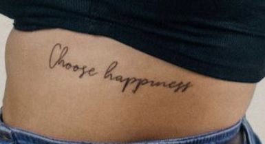 a woman's stomach with the words choose happiness tattooed on her lower side ribcage