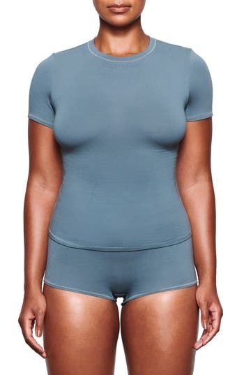 A tried-and-true classic, this fitted tee made from stretch-cotton jersey is from Kim Kardashian West's highly sought-out SKIMS. 21 1/2" length (size Medium) Crewneck 90% cotton, 10% elastane Machine wash, tumble dry Imported Women's Clothing Basic Seamless Snug Fit T-shirt, Seamless Crew Neck T-shirt For Loungewear, Seamless Solid Elastane T-shirt, Solid Seamless Elastane T-shirt, Blue Crew Neck Top In Elastane, Blue Elastane Crew Neck Top, Blue Crew Neck Elastane Top, Basic Snug Fit Seamless T-shirt, High Stretch Seamless Basic T-shirt