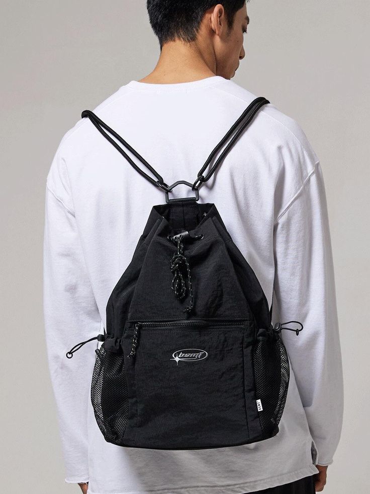 This is a casual and unique bag by BSMT that is made out of high quality and sturdy material. With distinctive mood of the design and comfortable wear, you can style it for your casual daily outfit.- Adjustable string and stopper on side and top- Miimal logo print detail- Casual and trendy mood Casual Shoulder Bag Backpack For Outdoor Activities, Casual Shoulder Backpack For Outdoor Activities, Sporty Large Capacity Chest Backpack, Sporty Black Chest Backpack, Versatile Nylon Backpack Gym Bag, Sporty Black Chest Bag With Zipper Pocket, Black Multifunctional Backpack For Outdoor, Sporty Shoulder Bag Backpack For Outdoor Use, Multifunctional Black Backpack For Outdoor