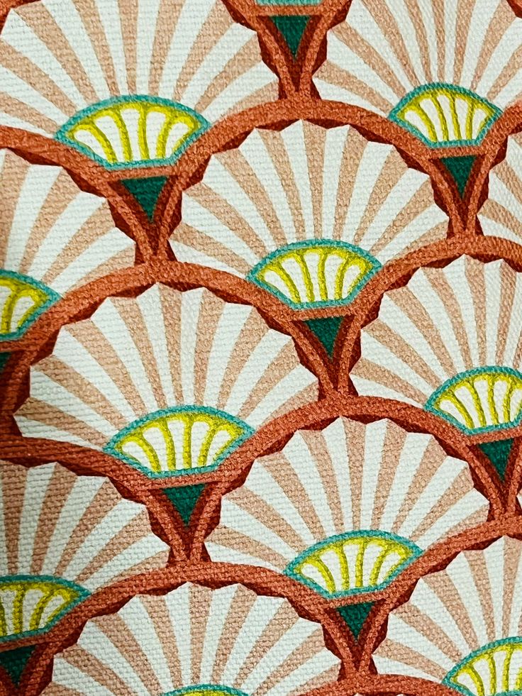 an orange and green fabric with fan designs on it