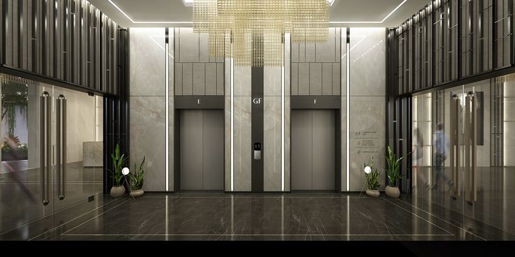 an empty lobby with two elevators and plants