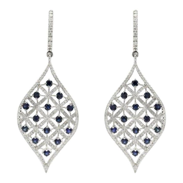 This is part of Chairish’s Fine Jewelry assortment.  Designer Blue Sapphire and Diamond Long Dangle Earrings to make a statement with your look. These earrings create a sparkling, luxurious look featuring oval cut gemstone. If you love to gravitate towards unique styles, this piece of jewelry is perfect for you.  PRODUCT DETAILS :-  > Material - 14K Solid White Gold > Gemstone - Blue sapphire  > Gemstone Weight - 1.88 ct > Gemstone Shape - Round  > Gemstone Pcs - 28   > Gemstone Size - 2.5 mm > Diamond Weight - 1.27 ct > Diamond size - 1 mm > Gross Weight - 13.79 Grams > Setting - Prong setting > Length - 55 mm  > Width - 21 mm White Gold Oval Earrings For Parties, Party White Gold Oval Earrings, Fine Jewelry Marquise Earrings For Evening, Oval Diamond Earrings For Party, Oval Gemstone Earrings For Evening, Elegant Sapphire Earrings With Diamond Cut, Elegant Oval Diamond Earrings With Gemstones, Elegant Marquise Earrings For Party, Elegant Pierced Sapphire Jewelry