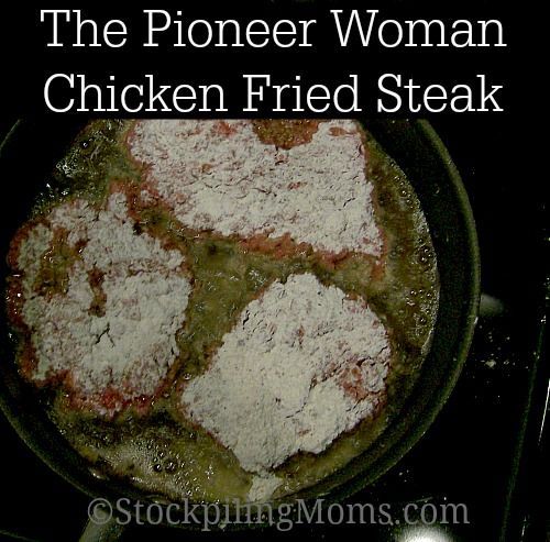 a pan filled with chicken fried steak on top of a stove