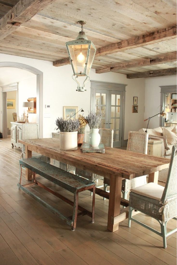 a dining room table with two chairs and a bench in front of the table is made out of wood planks