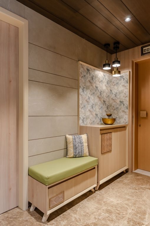 a wooden bench sitting next to a door in a room with wood paneling on the walls