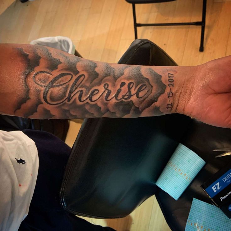 a man's arm with the word cherse tattooed on it