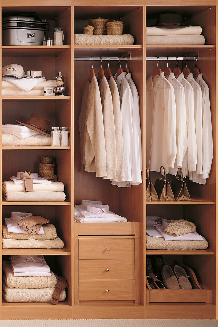 an organized closet with clothes and shoes