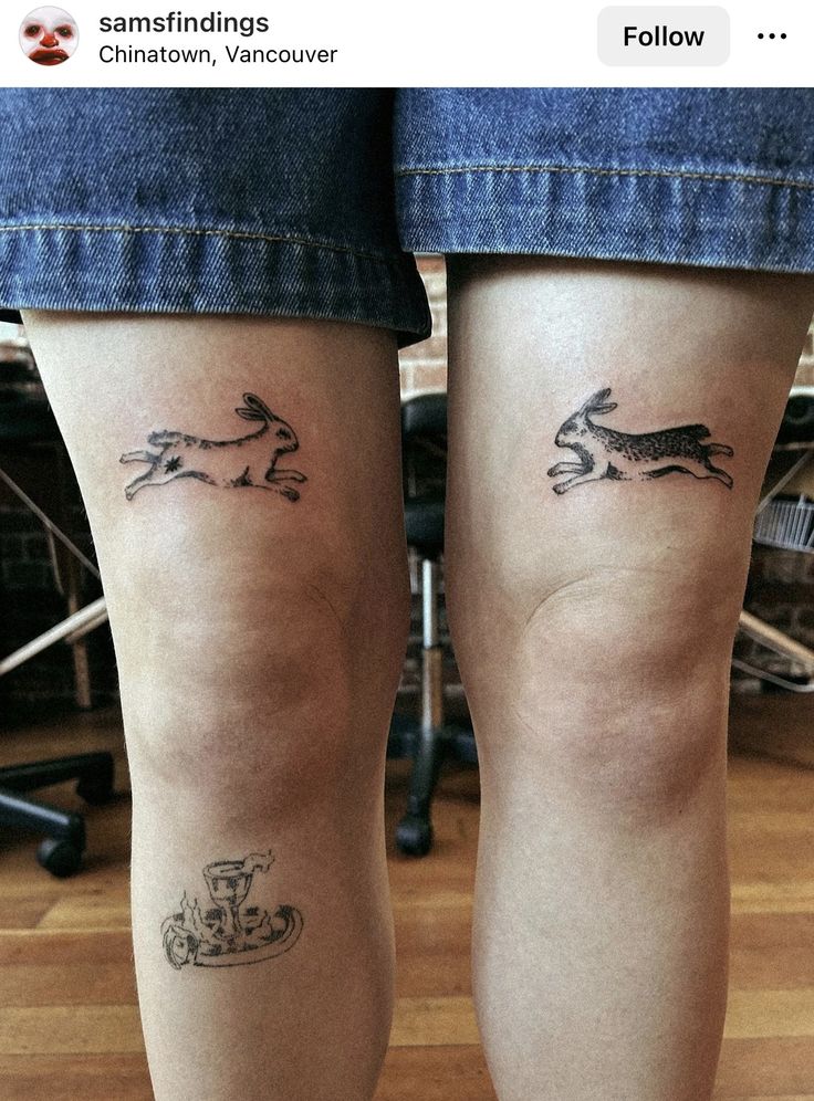 two small tattoos on the legs of people with dogs and motorcycle symbols tattooed on them