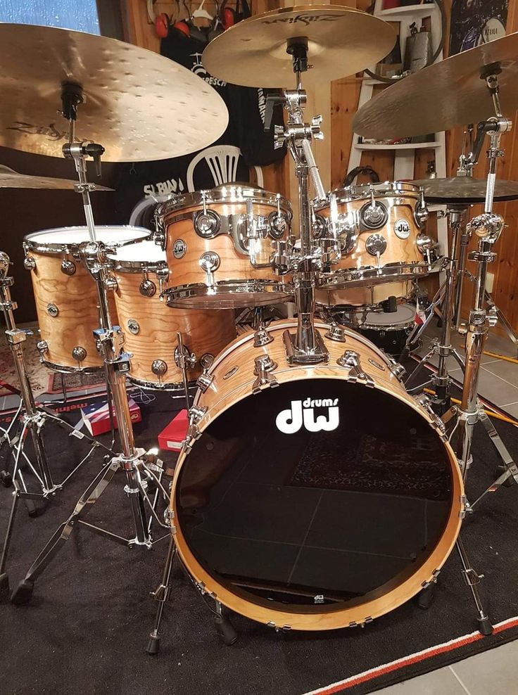 a drum set sitting on top of a black floor