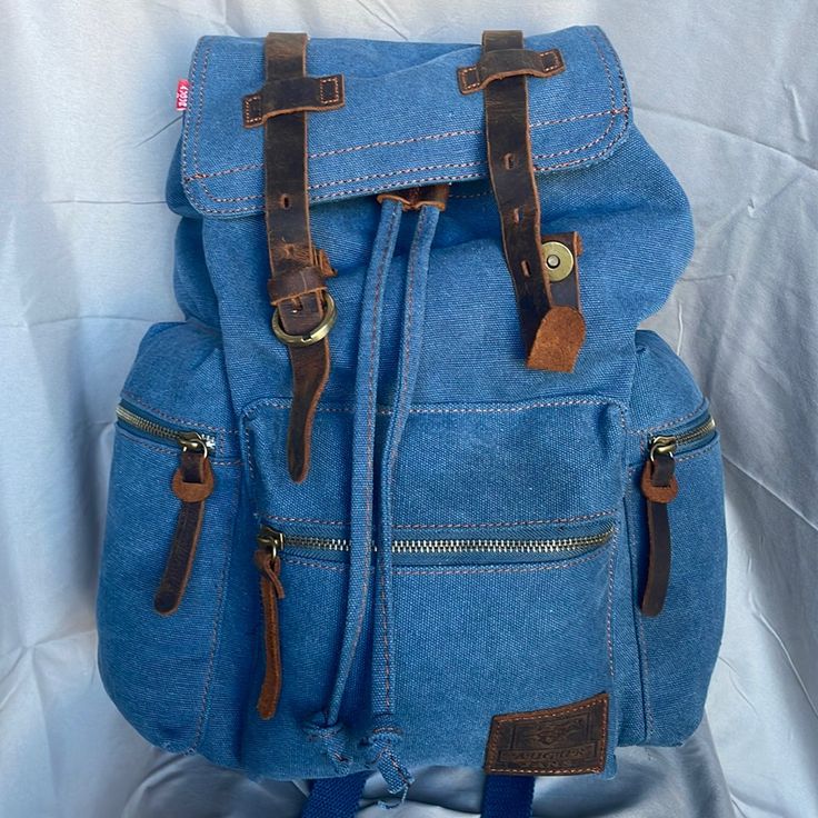 Brand New. Never Used. Only Flaw Is Button Is Missing To Attach To Close On One Side (Please See Pic) 3 Outside Pockets 12”-Length 5”- Deep 15”- High Blue Backpack With Pockets For Everyday Use, Casual Canvas Backpack With Zipper Pocket, Casual Backpack With Zipper Closure, Casual Blue Backpack For Daily Use, Casual Denim Blue Backpack For Daily Use, Casual Cotton Backpack For Daily Use, Casual Cotton Backpack For Back To School, Casual Backpack For Everyday Use, Casual Blue Backpack