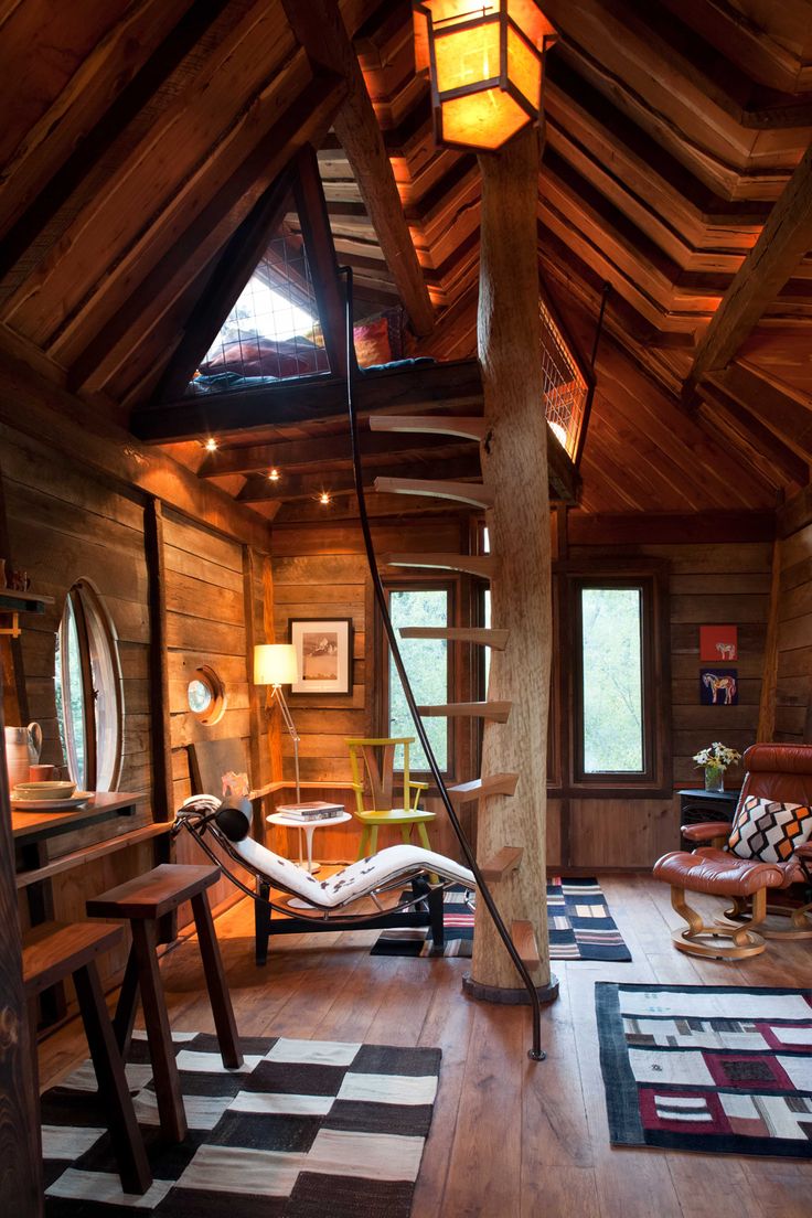 the inside of a log cabin with a hammock